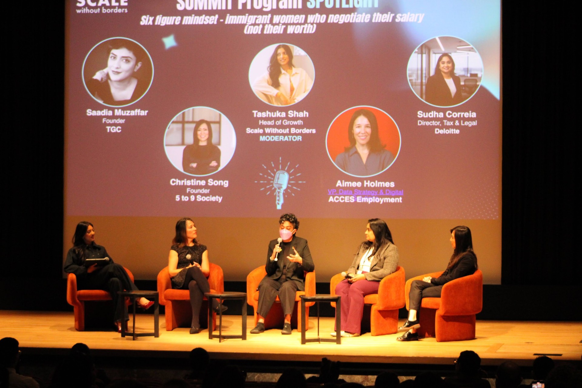 Tashuka Shah moderating a panel at the Immigrant in Tech Summit, Royal Ontario Museum